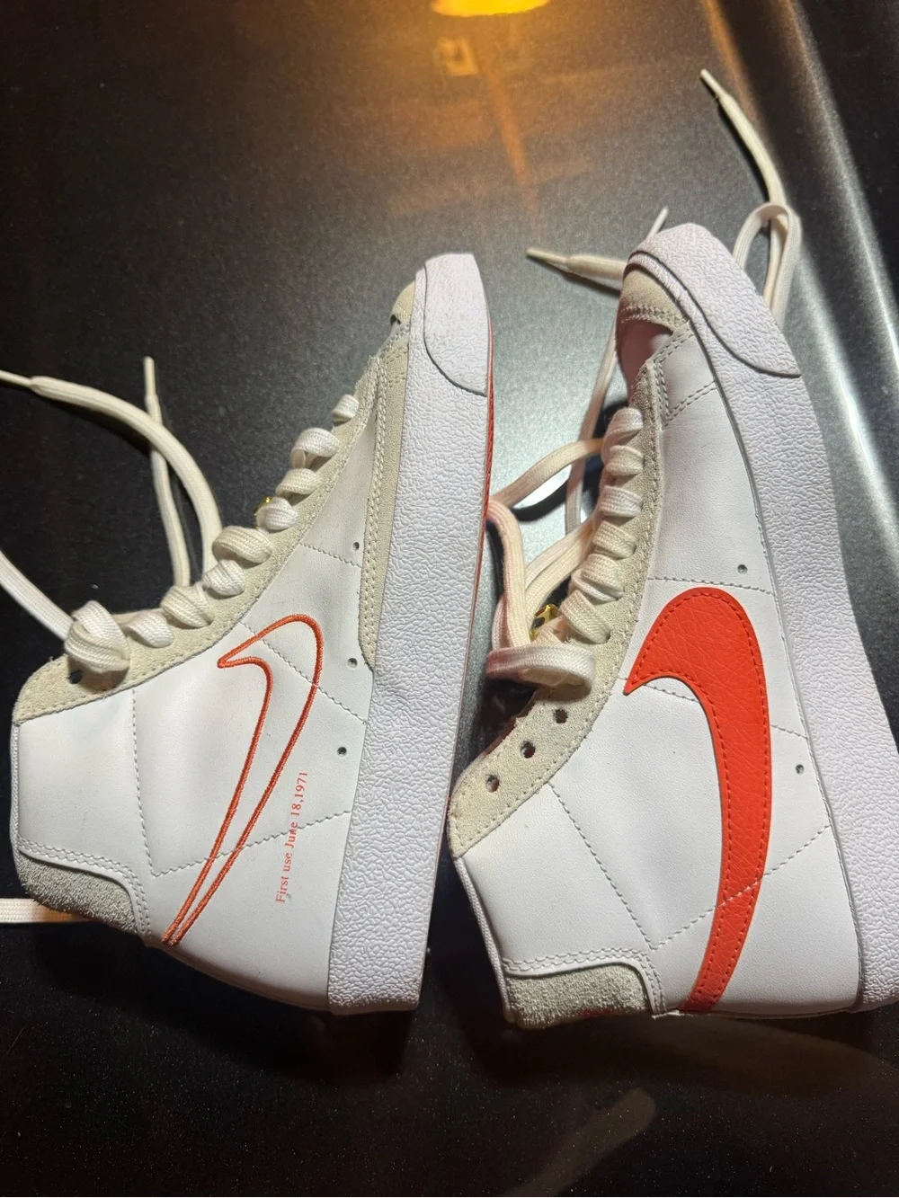 Nike White High-Top Sneakers with Orange Swoosh